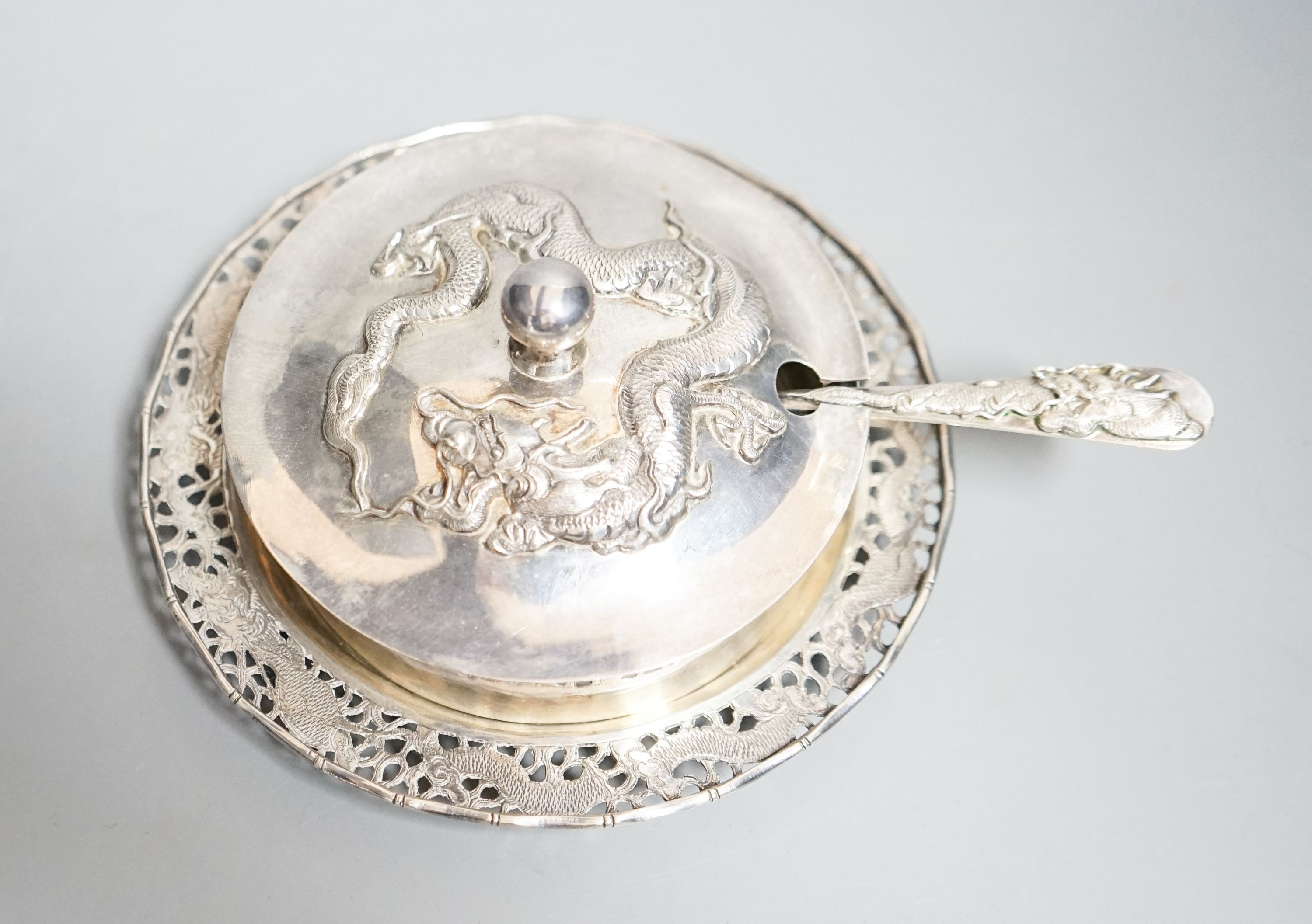 A Chinese white metal butter dish, on stand with knife by Tack Hing, with glass liner, 14.2cm.